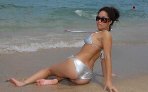 Black broad with curly hair gives up and moreover allows photographer to spy on her