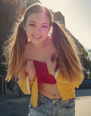 Playful teenage with cute pigtails knows how to turn any man on