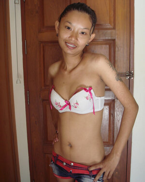 Slim Asian girl is going to show naked body in a doorway