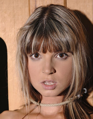 Cutie Gina Gerson gets fingered while bound to a wooden construction