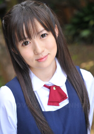 Innocent Japanese schoolgirl with charming eyes walks seductively under sun