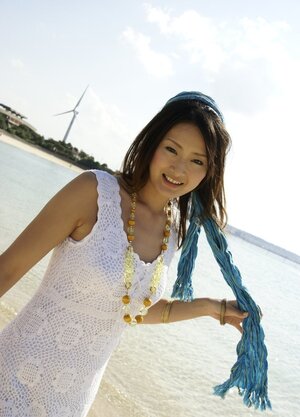 Smoking hot Japanese girl in white dress walks into the water being dressed