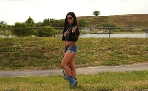 Hoe with sunglasses opens jacket demonstrating she doesn't wear bra