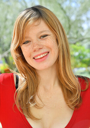 Pornographic broad with freckled face shows the color of panties pulling skirt up