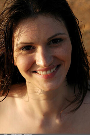 Cutie pie with bush relaxes undressed while walking on the beach and swimming in the sea