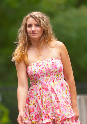 Beauty with wavy hair flashes her natural bra buddies and also lovely ass outdoors