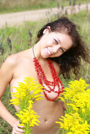 Joyful brunette with wavy hair gladly demonstrates her milk sacks in the fresh air