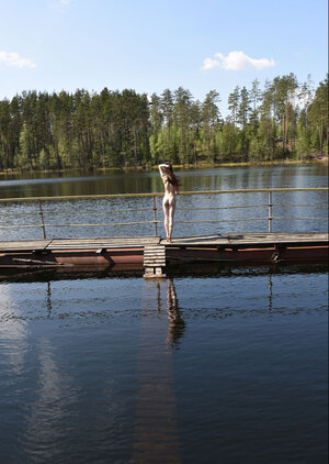 Sexy slut deletes flower dress on the pier and additionally goes posing naked in the puddle
