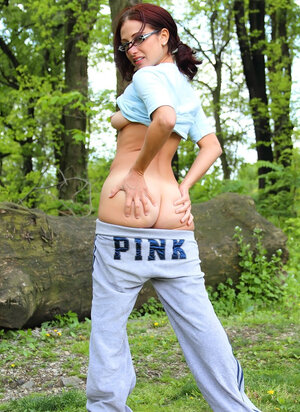 Beautiful redhead with glasses comes to the woods to demonstrate her tits and moreover pussy