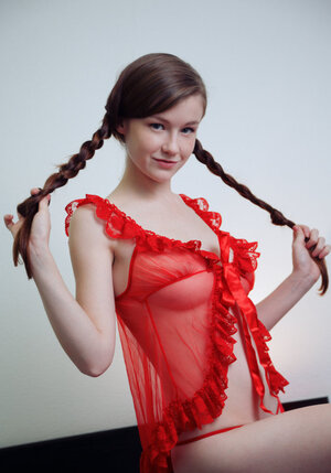Small wench with pigtails takes off red underwear to show her hairy teen twat