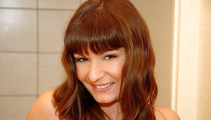 Excited babe reveals perky breasts and smooth peach during modeling in the bathroom