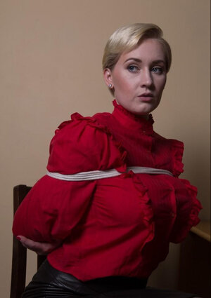 It surely is comfortably for performer in red shirt and plus black skirt to be hogtied