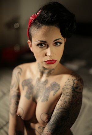 Inked brunette has quite enough talent to pose nude in image of pinup model